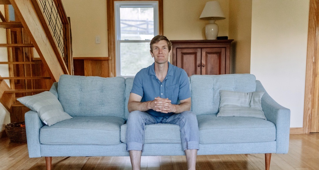 Ezekiel Fugate seated in his living room